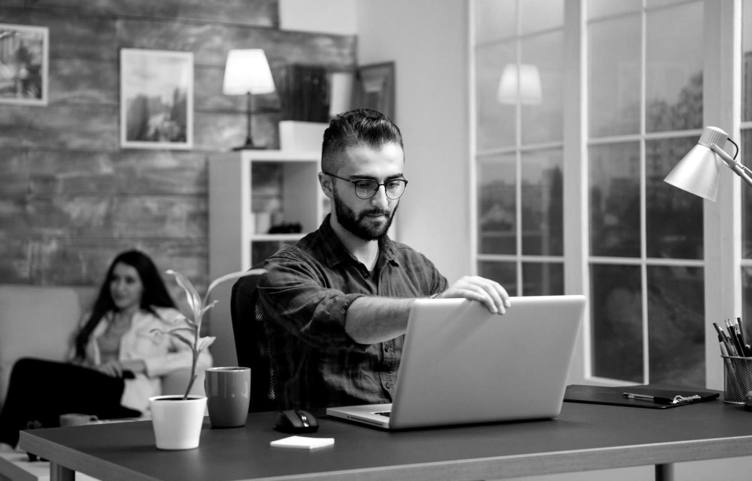 Modern office environment with team members reviewing investment portfolios and market analysis