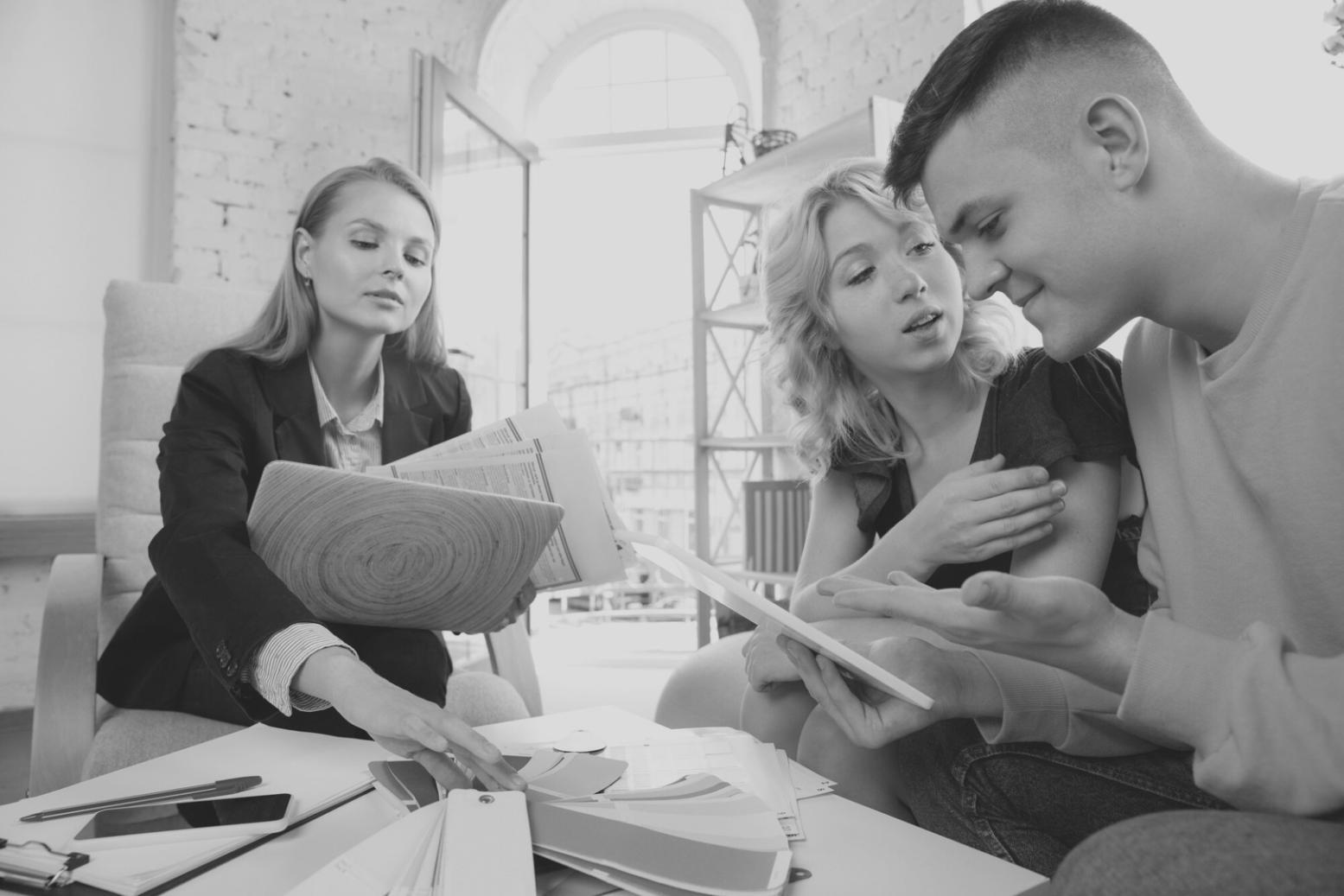 Financial professionals reviewing investment reports and analytics on computer screens